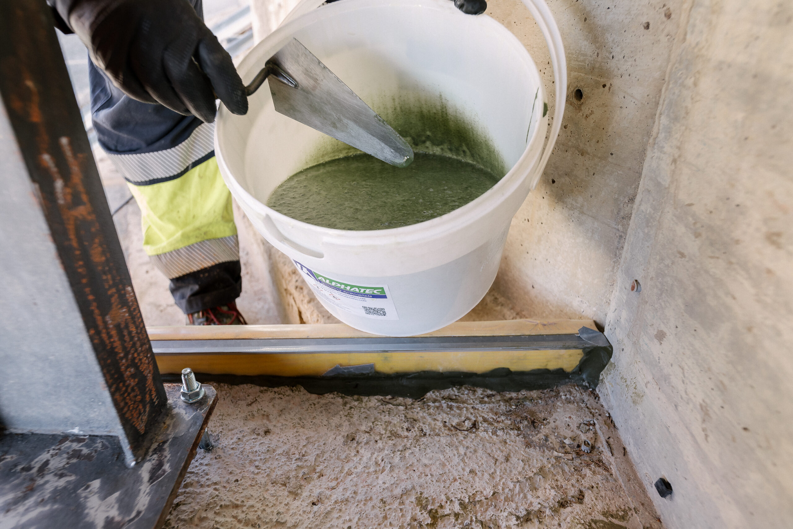 epoxy grout being poured for heavy machinery foundation
